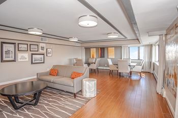 A living room with a grey couch and a coffee table.